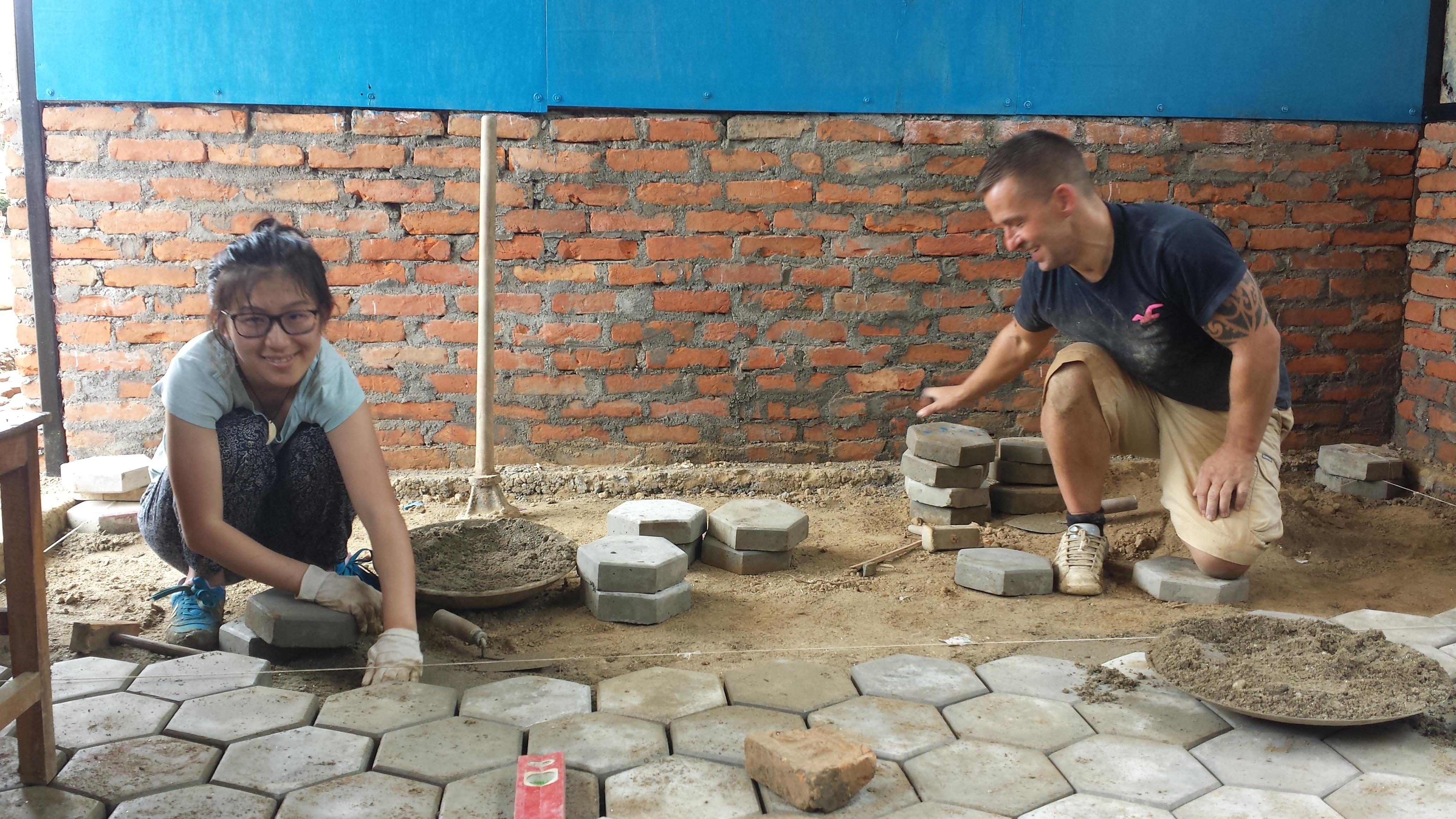 Volunteers lay concrete slabs as part of their building volunteer work in Nepal. Projects Abroad volunteers assist in laying concrete slabs whilst on their building volunteer work in Nepal.